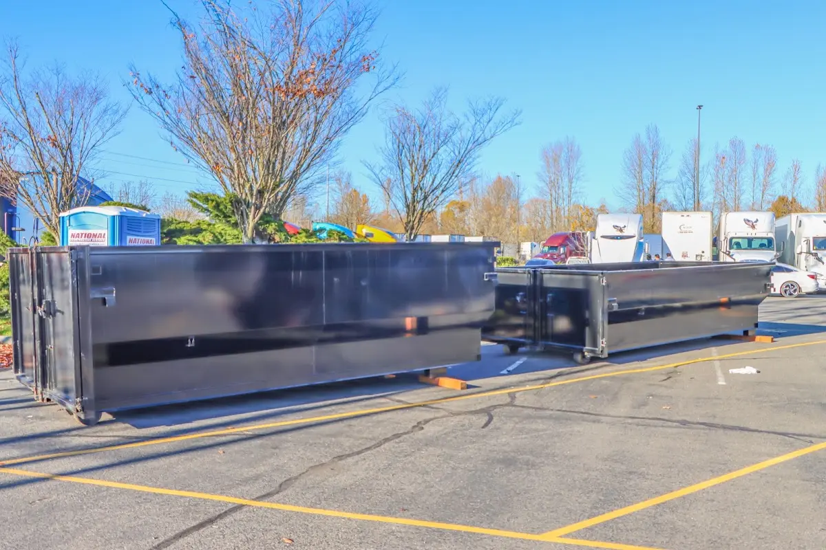 Professional dumpster rental service with roll-off container on residential driveway in Woodruff